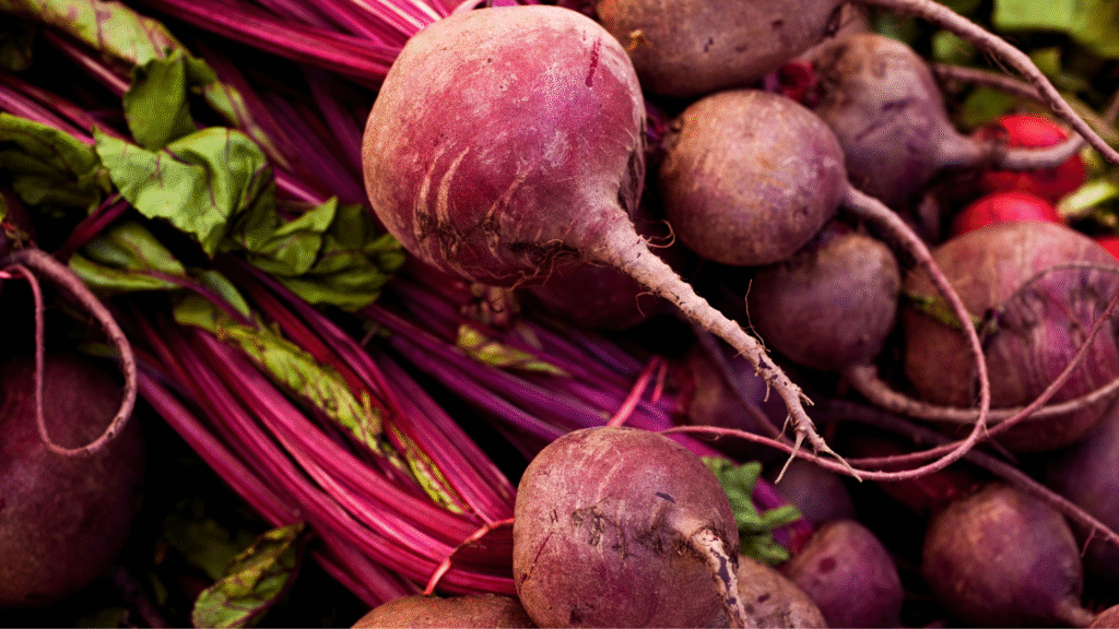 Ripe, red sugar beets with stalks and leaves. Made robust with the help of satellite IoT agricultural sensors.